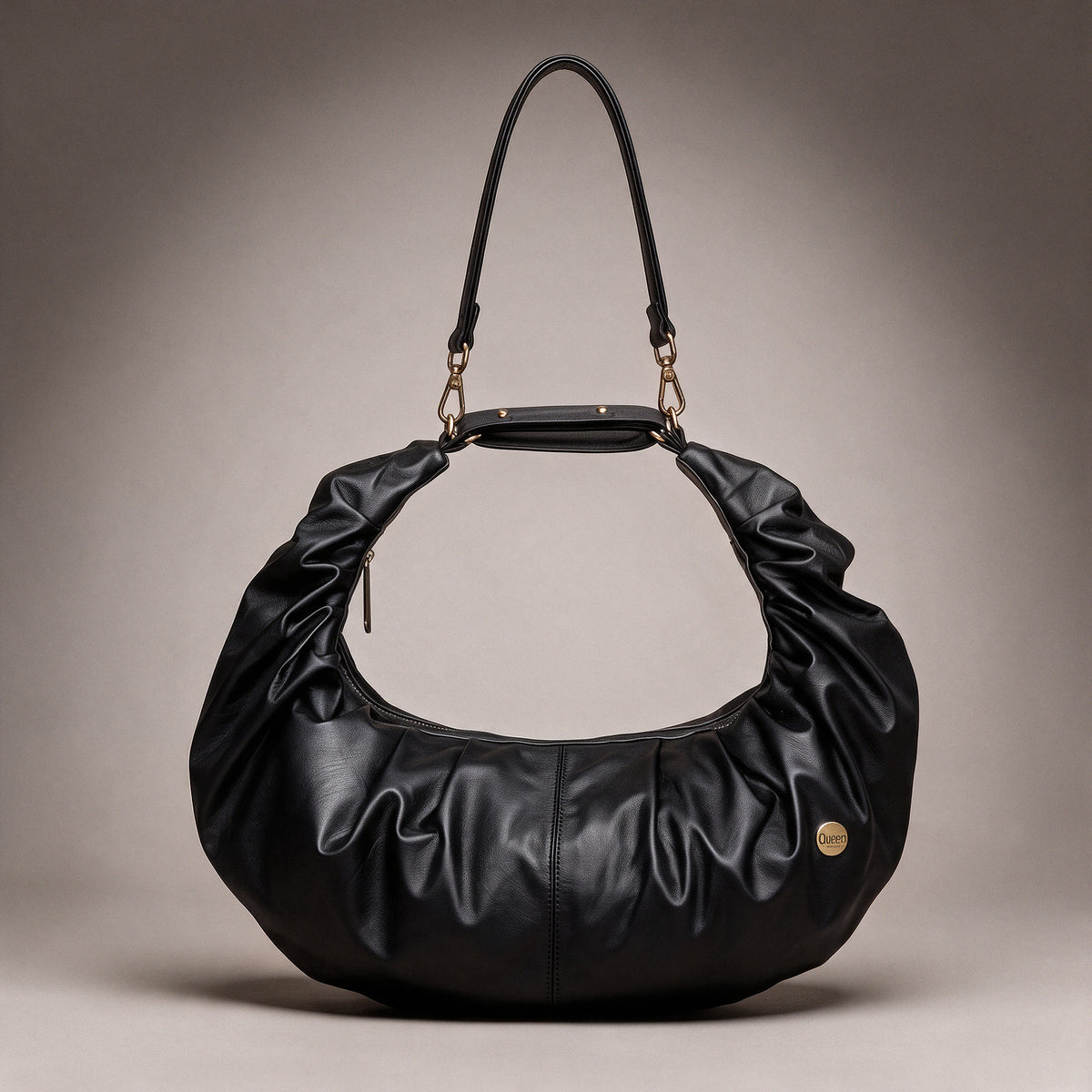 Bolso Renata Negro en cuero negro fruncido visto de frente sobre fondo greige de estudio